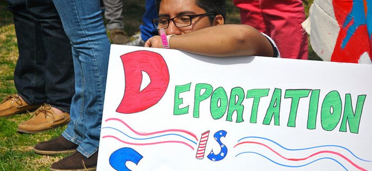 man-holding-deport-sign